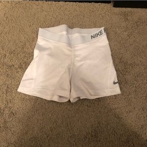 White Nike pros in a size medium